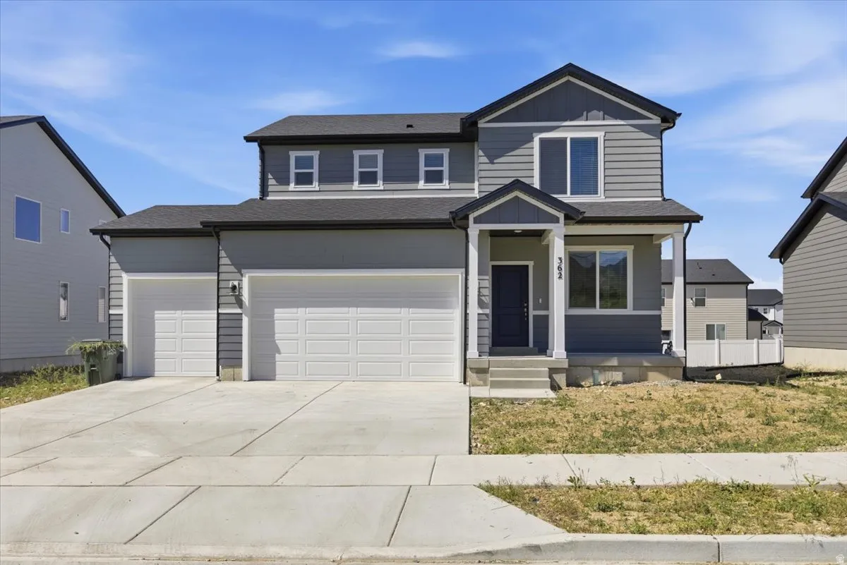 Two-story residence featuring gray siding and dark trim accents