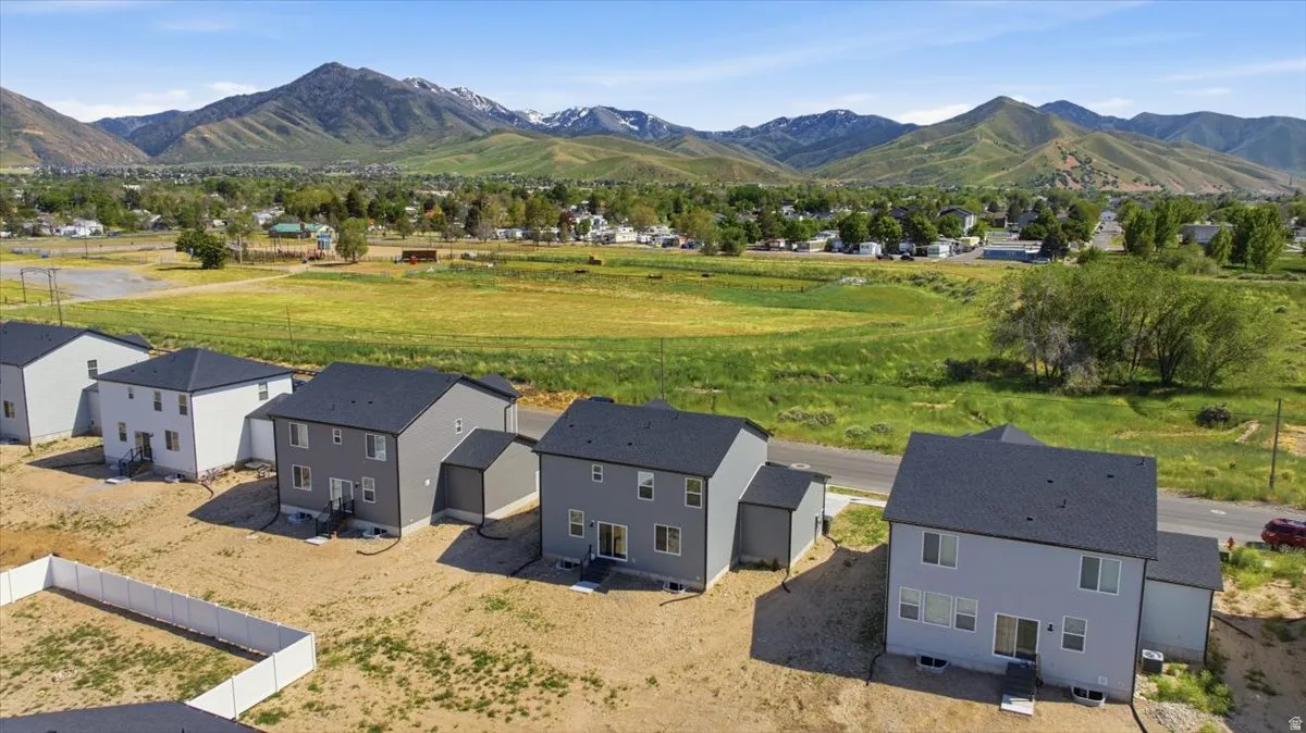 Newly constructed residences featuring dark shingle roofing and light-toned siding