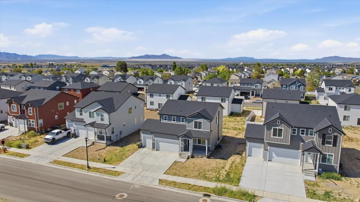 Newly constructed residential properties featuring contemporary designs, attached garages, paved driveways, and dark shingle roofs
