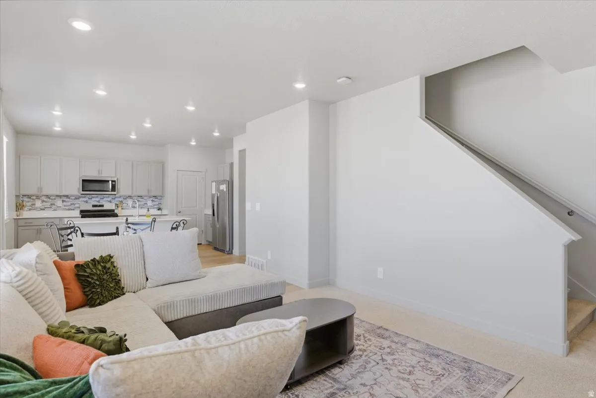 Open-concept living area featuring recessed lighting and light-toned walls