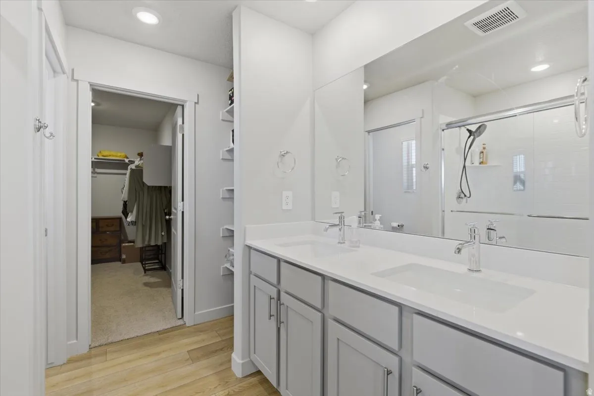 Dual vanity with undermount sinks, stone countertops, and contemporary faucets