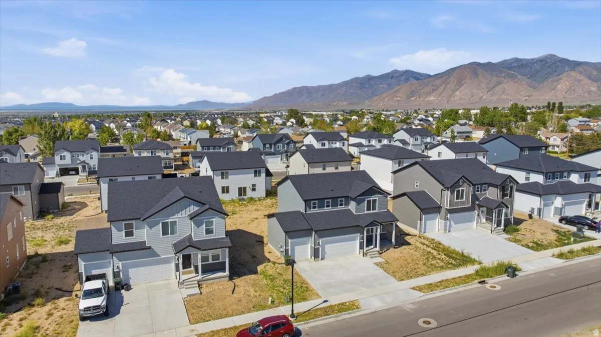 New construction home featuring a light gray exterior with dark trim and a two-car garage