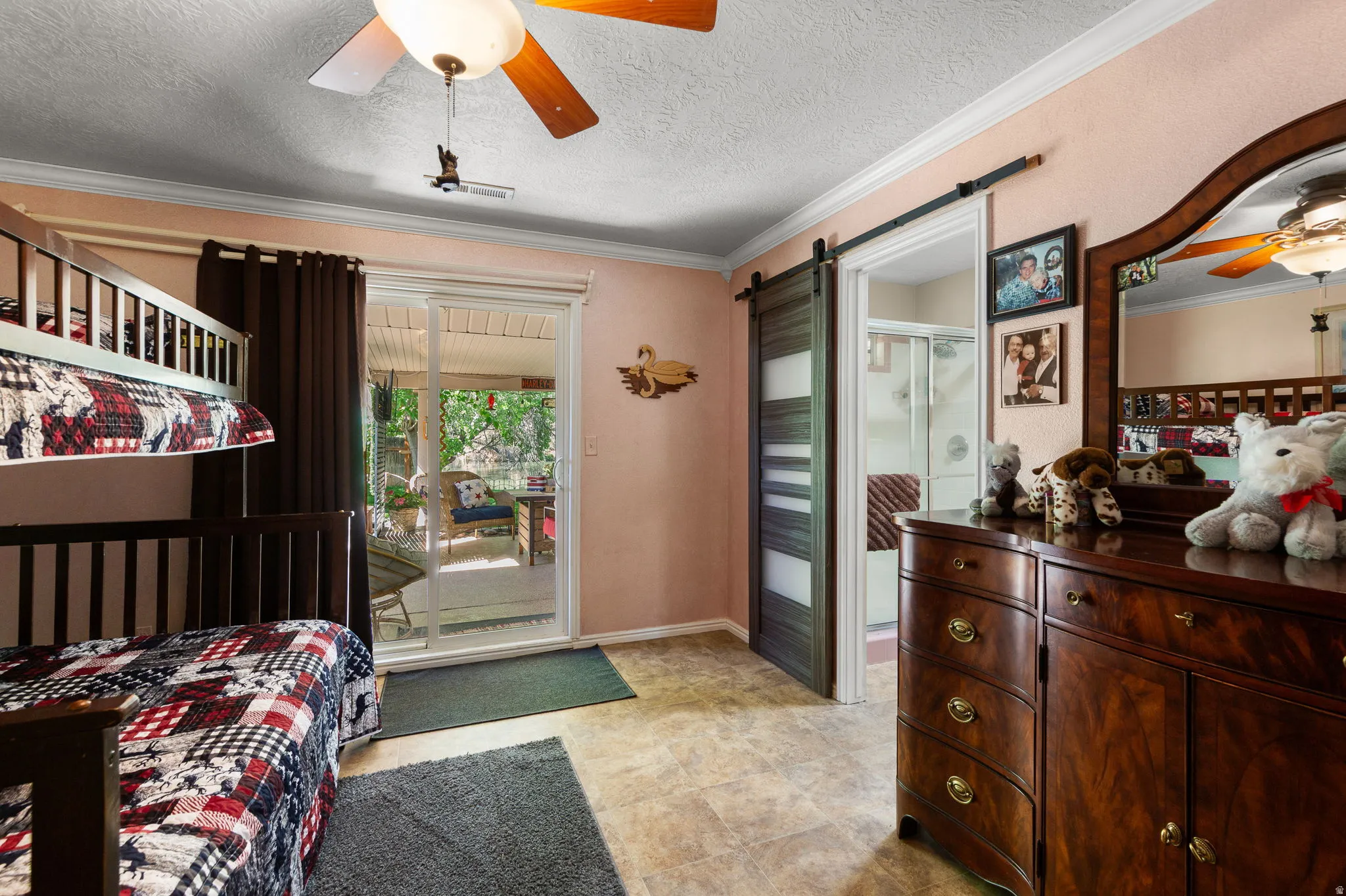Sliding glass door opening to an outdoor patio with a ceiling fan