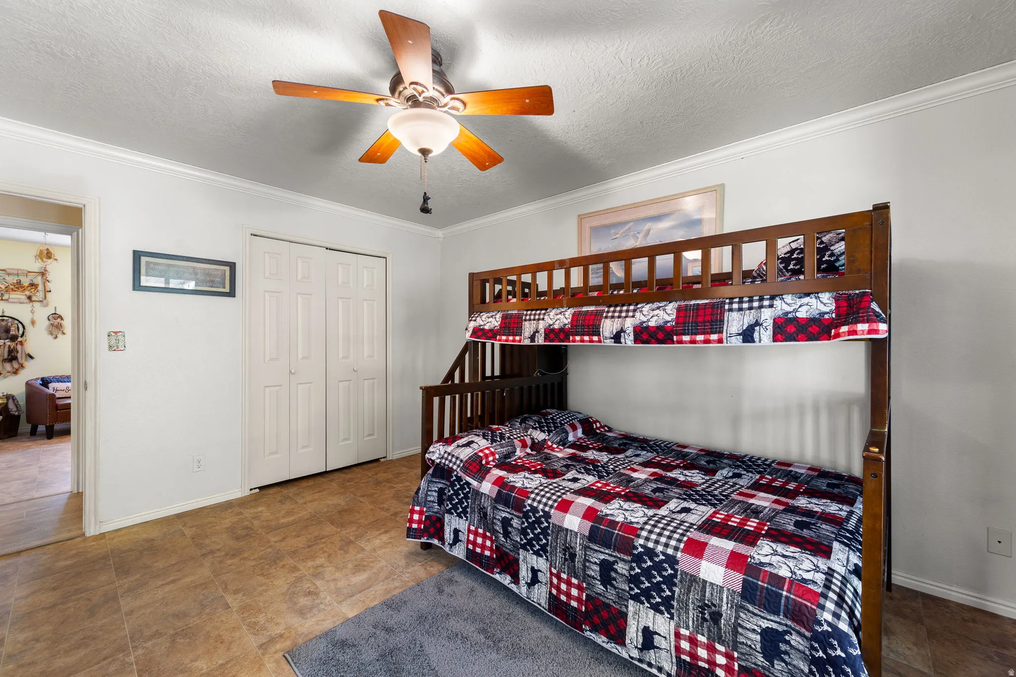 Room featuring wood-finish flooring, white walls, and crown molding