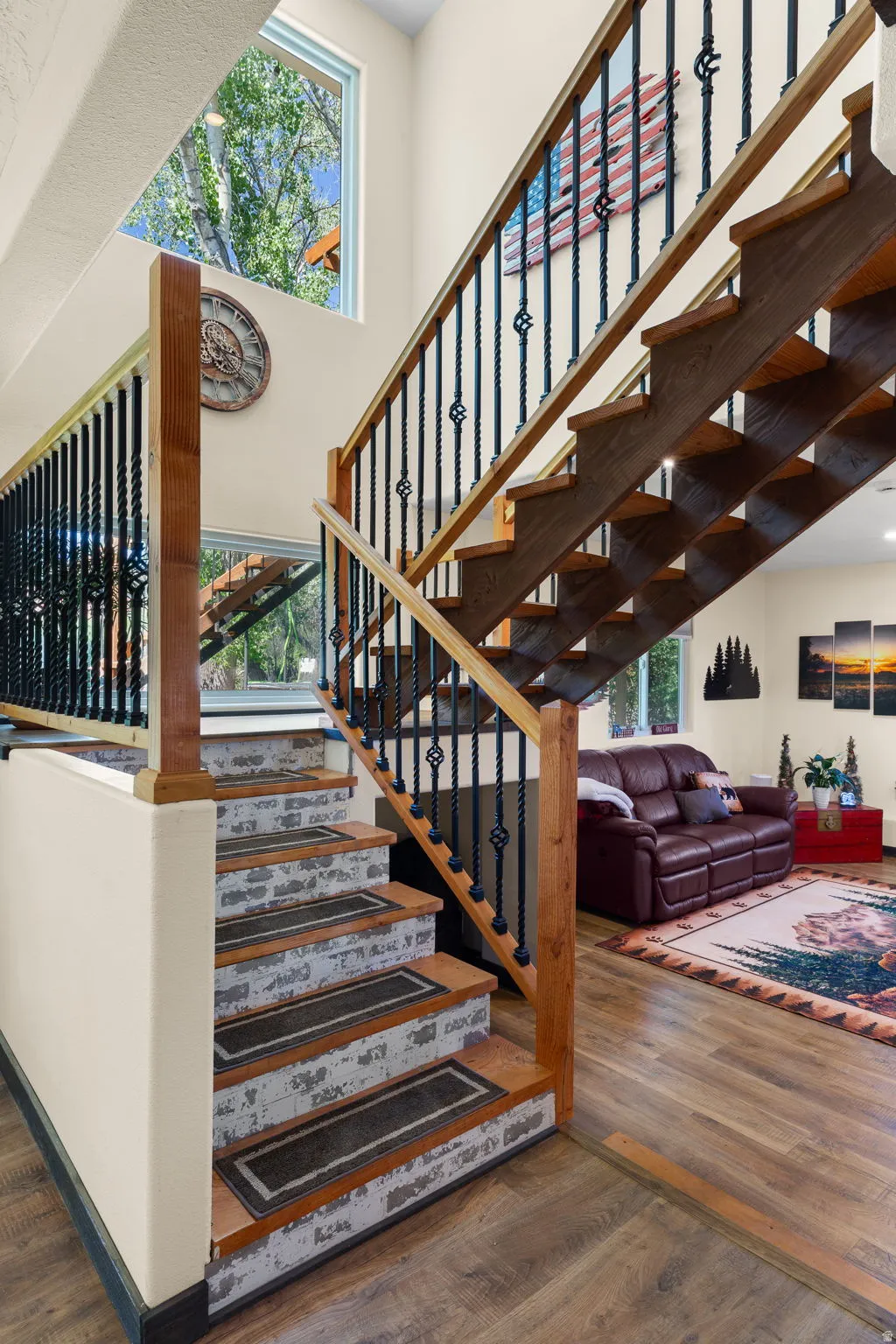 Open staircase featuring wood treads and wrought iron balusters