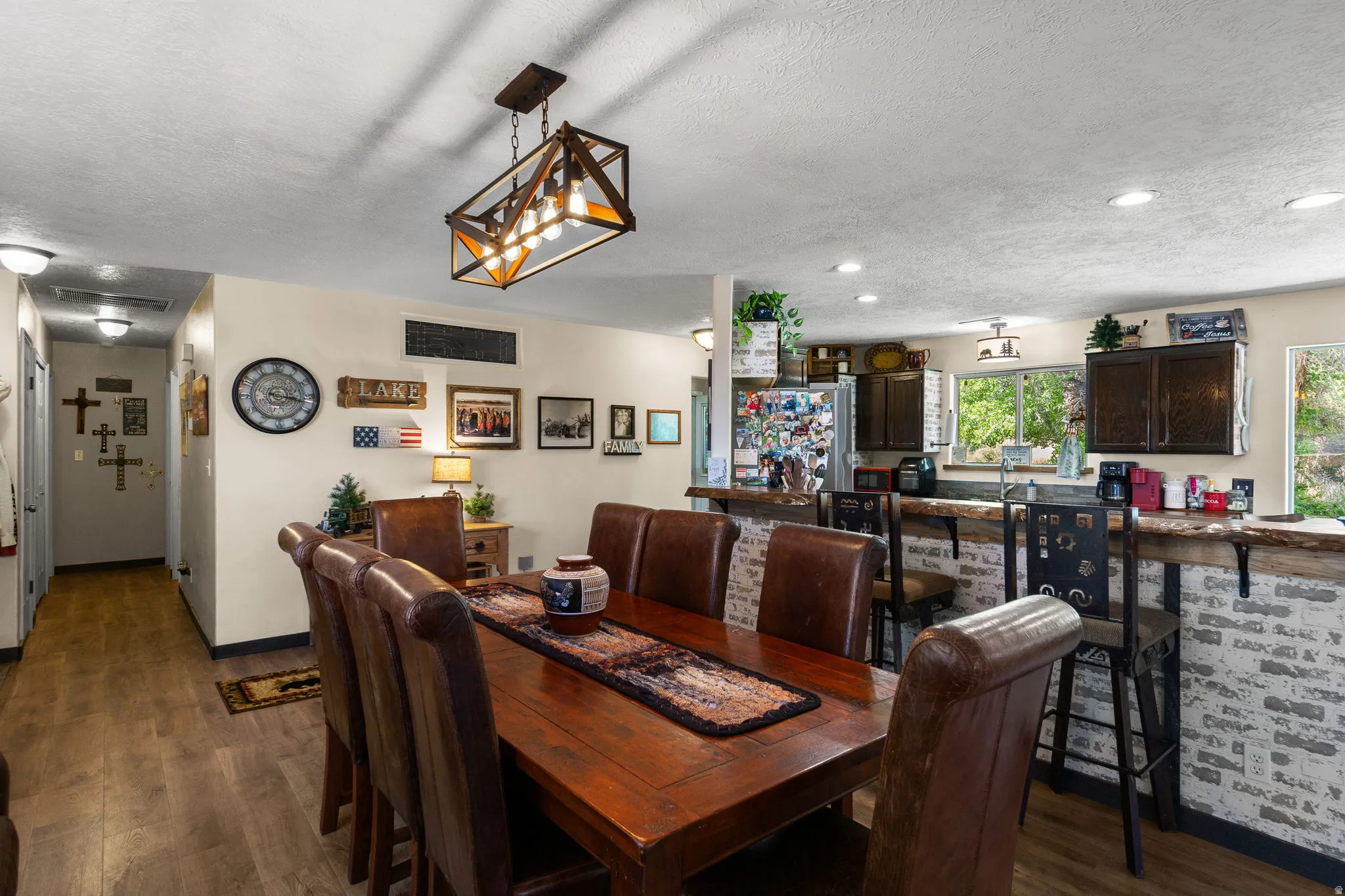 Open concept dining area featuring wood-finish flooring, a linear chandelier, and recessed lighting
