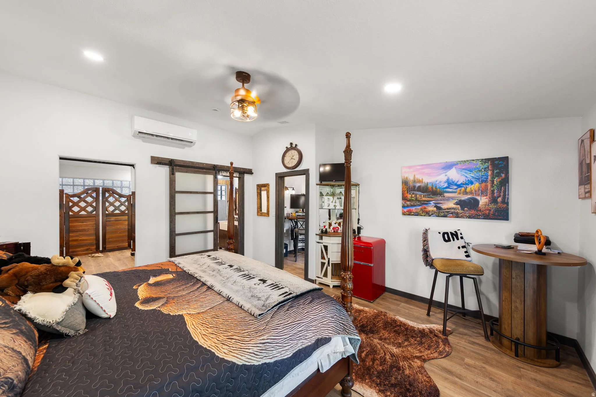Spacious room featuring wood-finish flooring, recessed lighting, and a ceiling fan