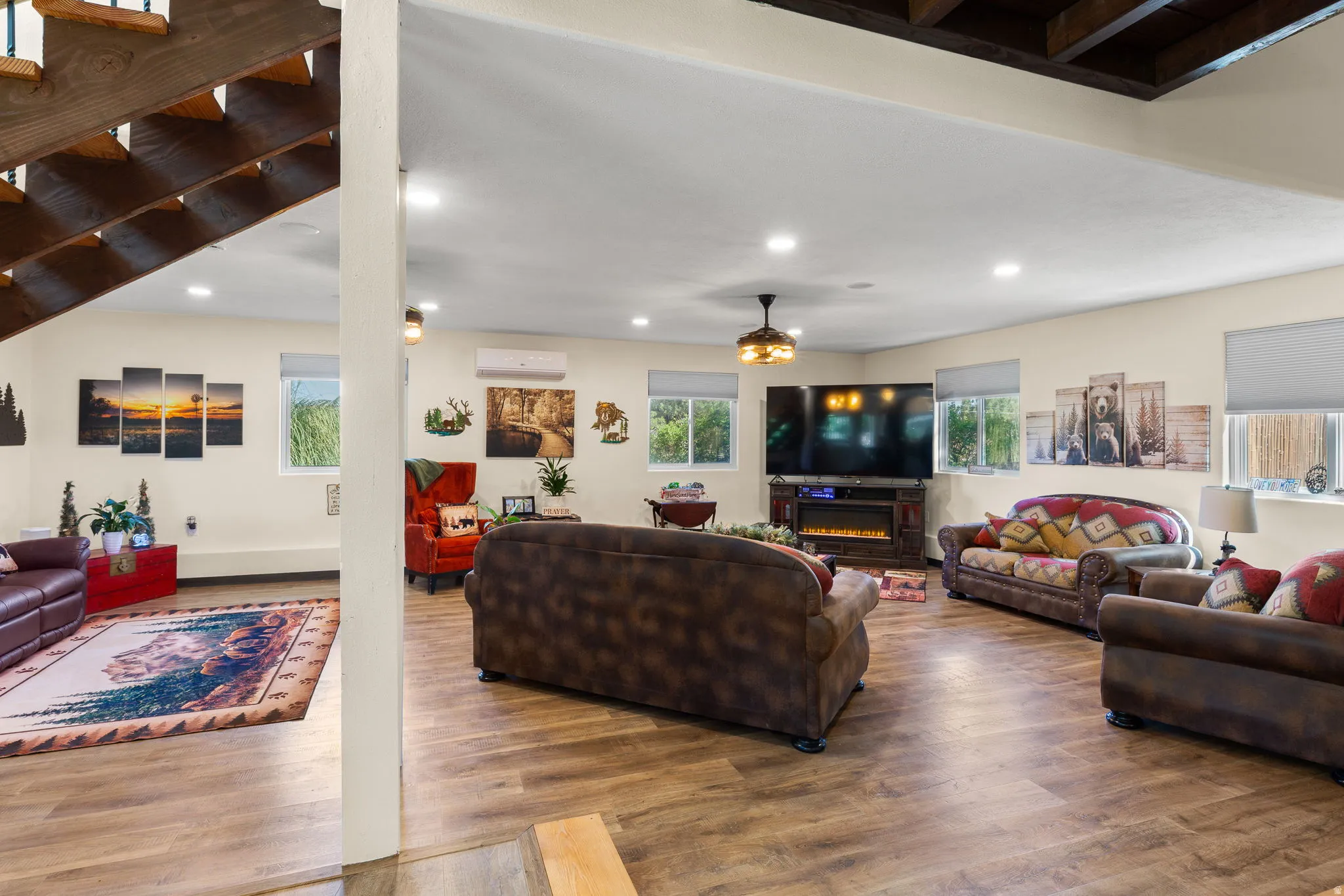 Spacious lower-level living area featuring wood-finish flooring, recessed lighting, and multiple windows