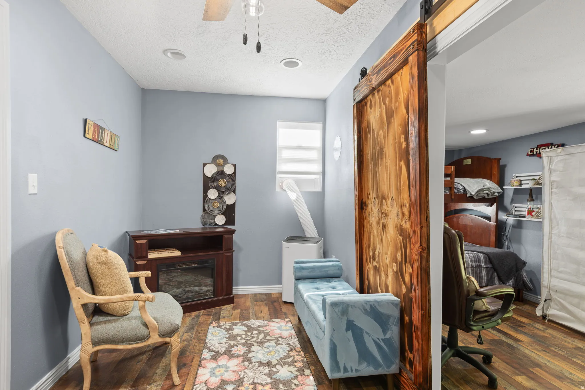 Light blue walls and wood-finish flooring define this interior space