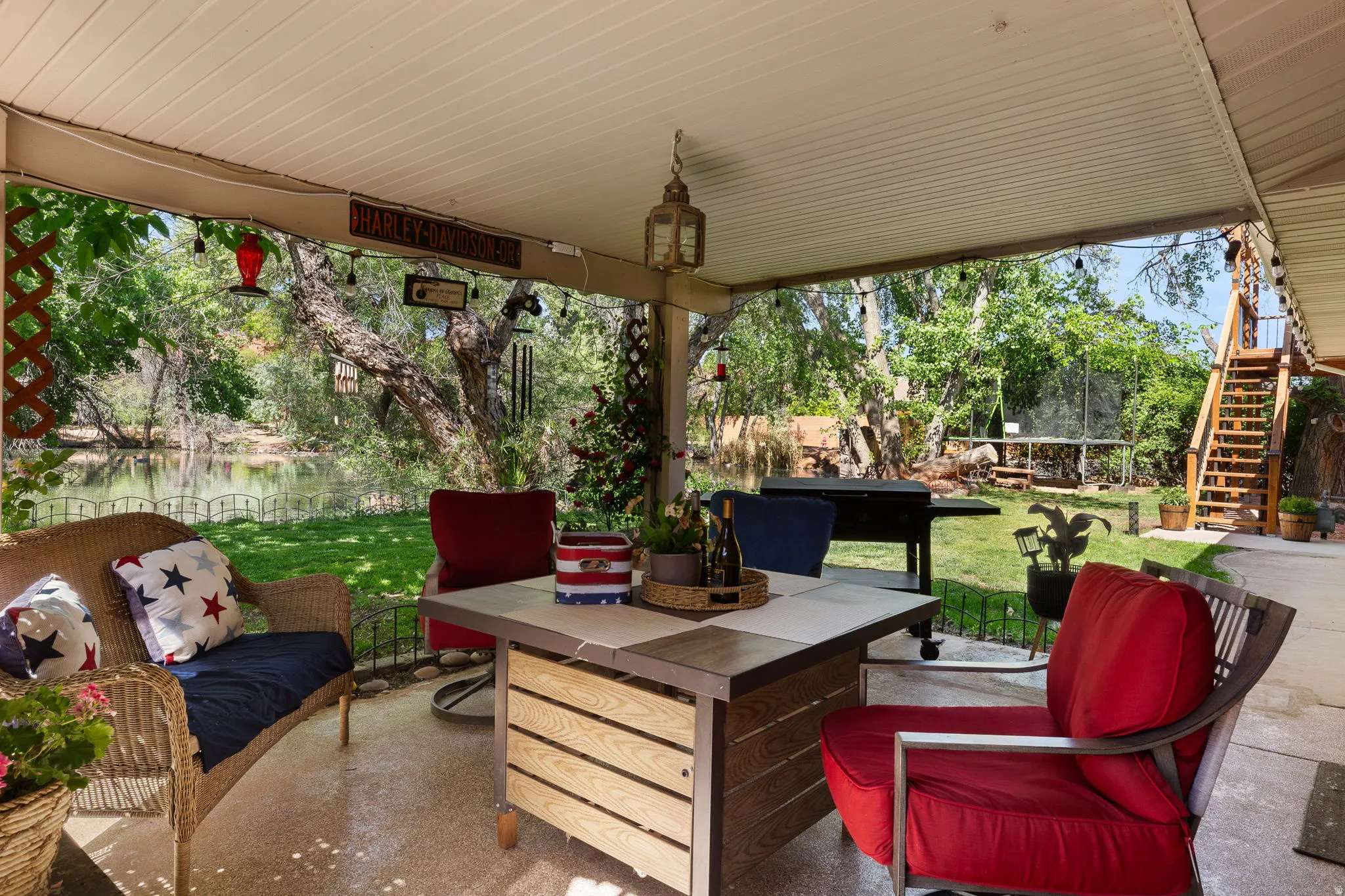 Covered patio featuring concrete flooring and a suspended light fixture