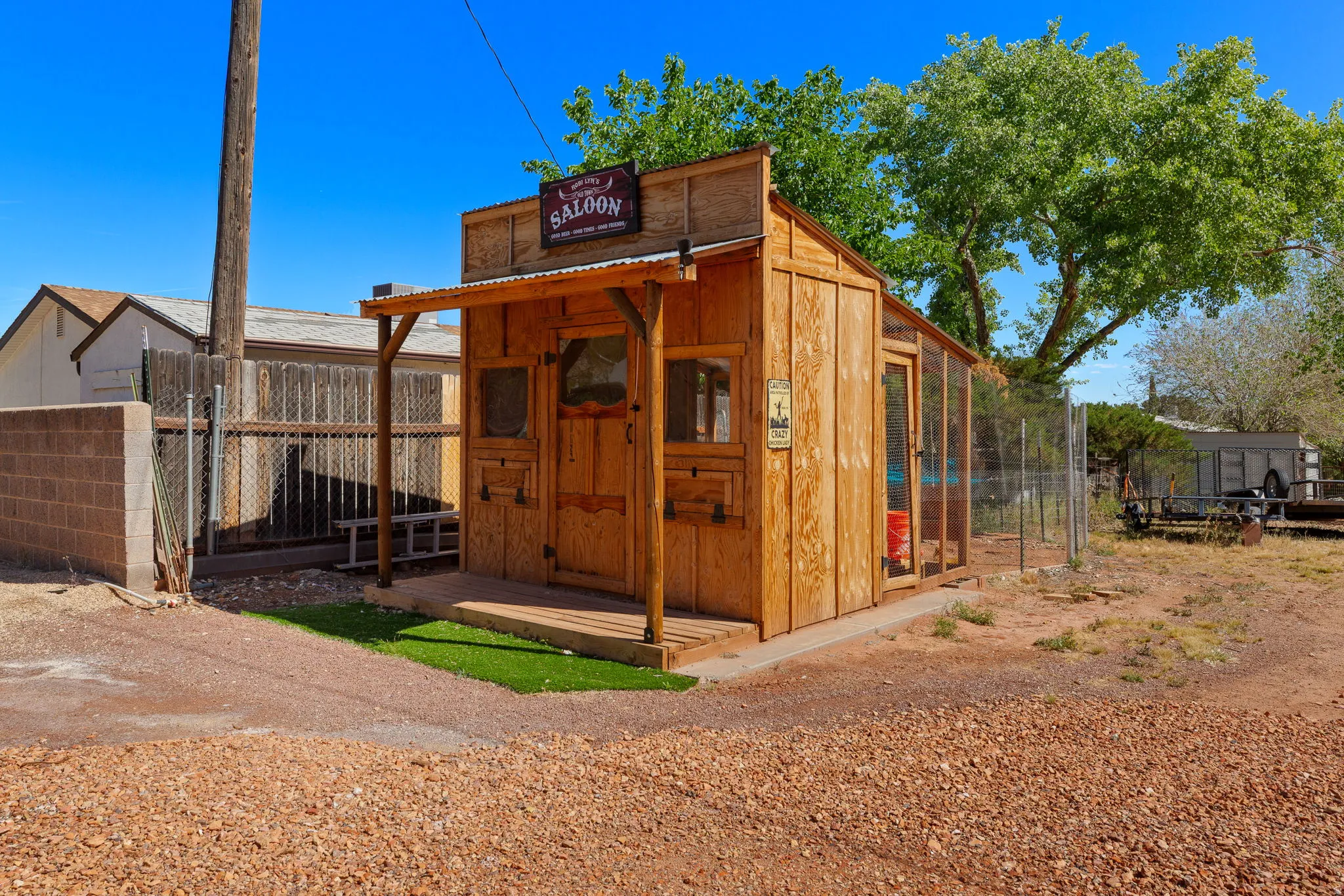Custom-built shed with a saloon-style facade, featuring a corrugated metal roof and a covered porch