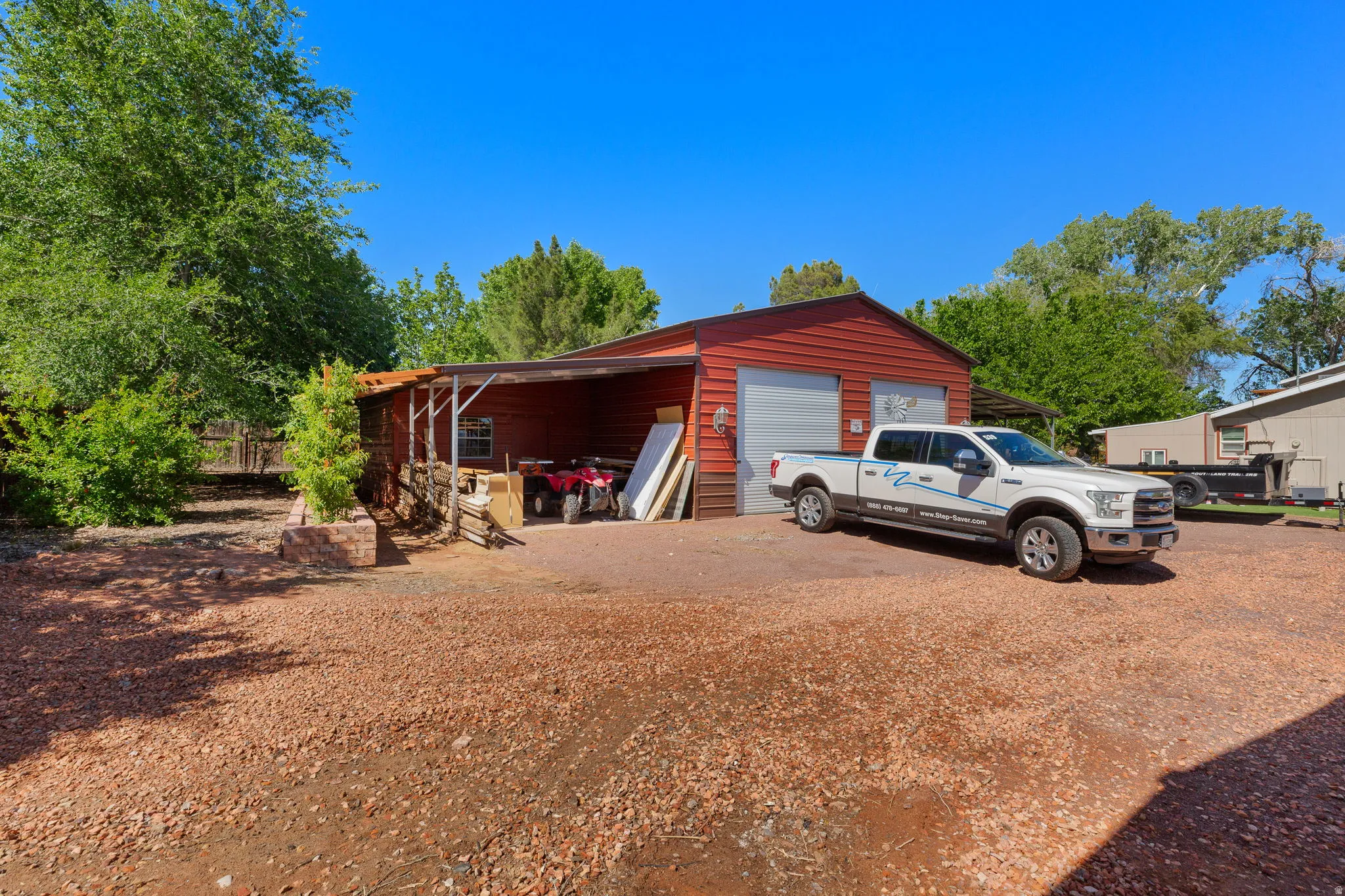 Red exterior workshop with two roll-up garage doors