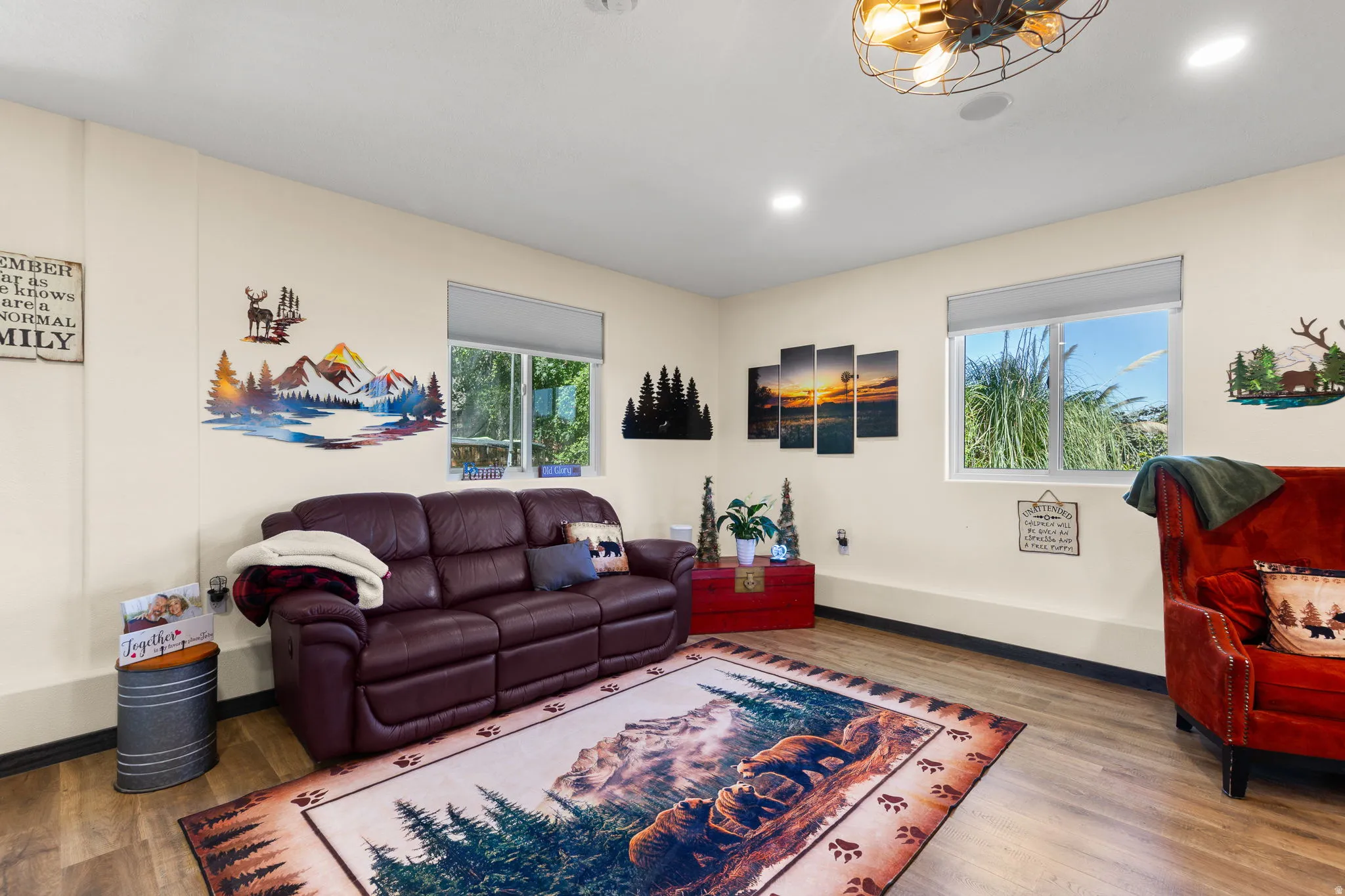 Spacious room featuring wood-finish flooring, two large windows, recessed lighting, and a ceiling-mounted light fixture