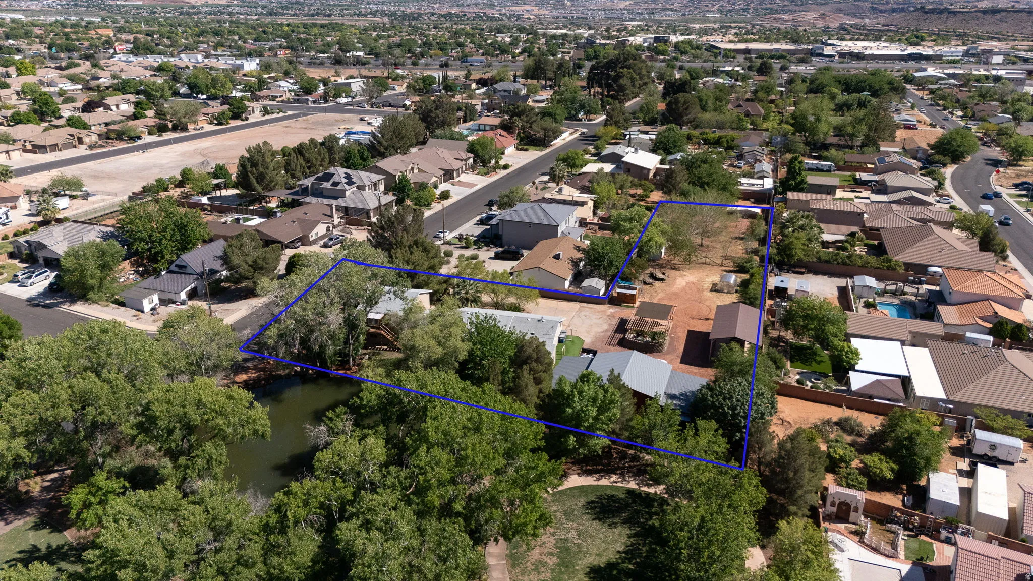Expansive parcel featuring mature trees, a natural water feature, and a substantial undeveloped land area