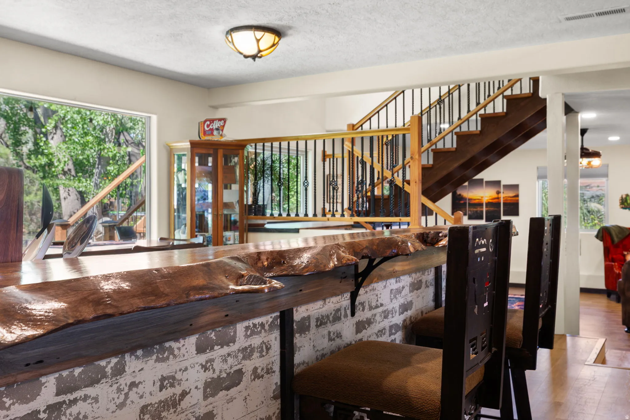 Custom bar featuring a copper-finish countertop, distressed brick base, and integrated seating