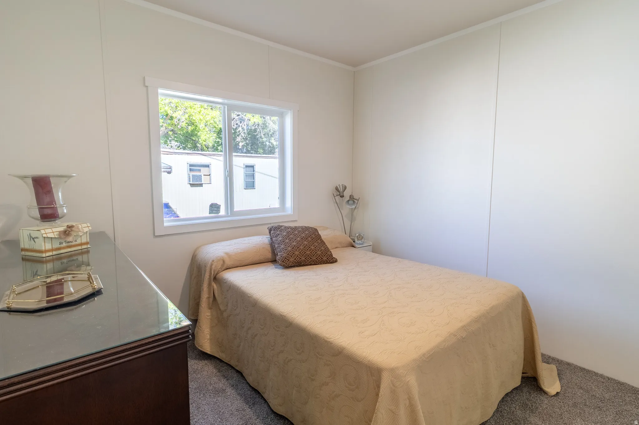 Carpeted bedroom featuring crown molding