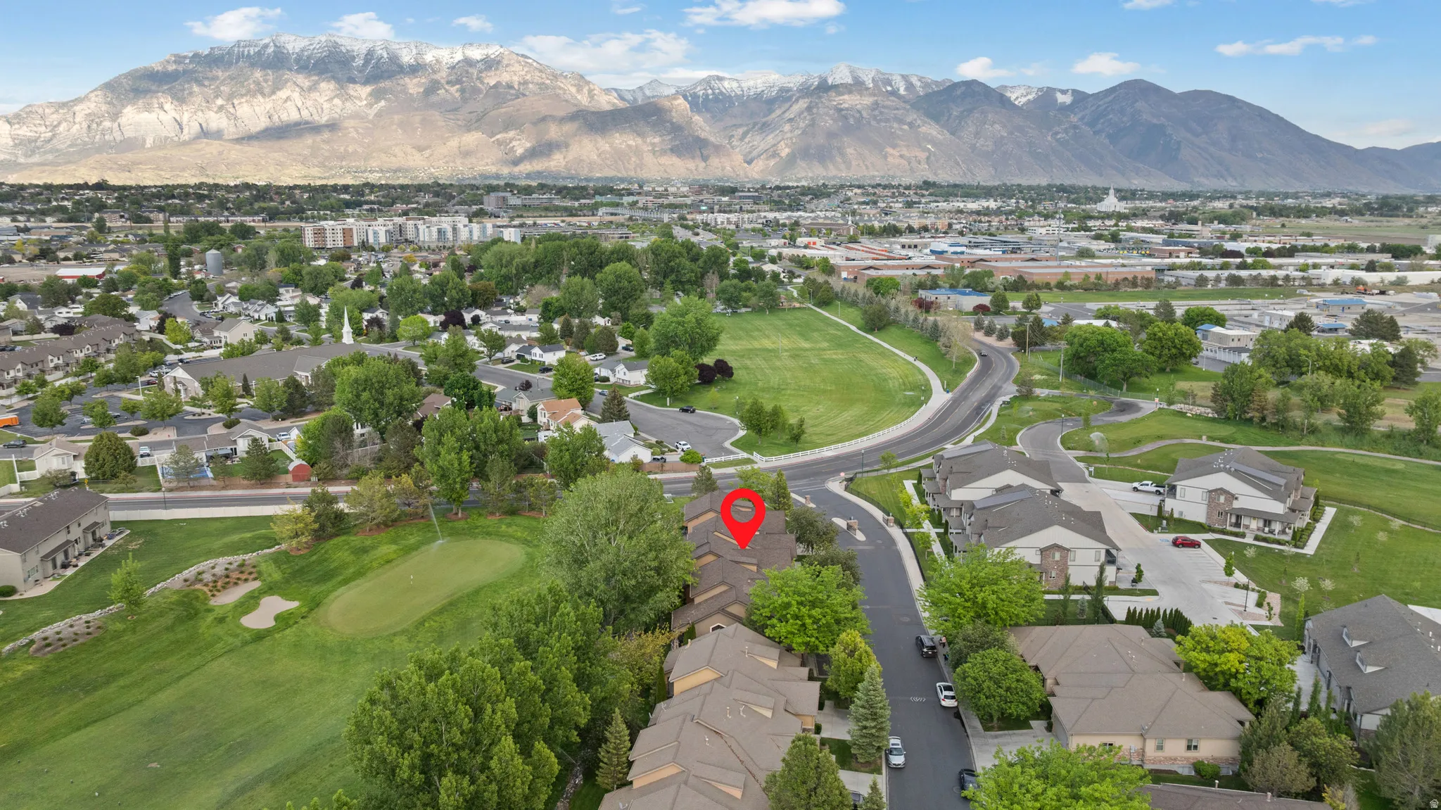 Aerial perspective showcasing residential properties with a mountainous backdrop