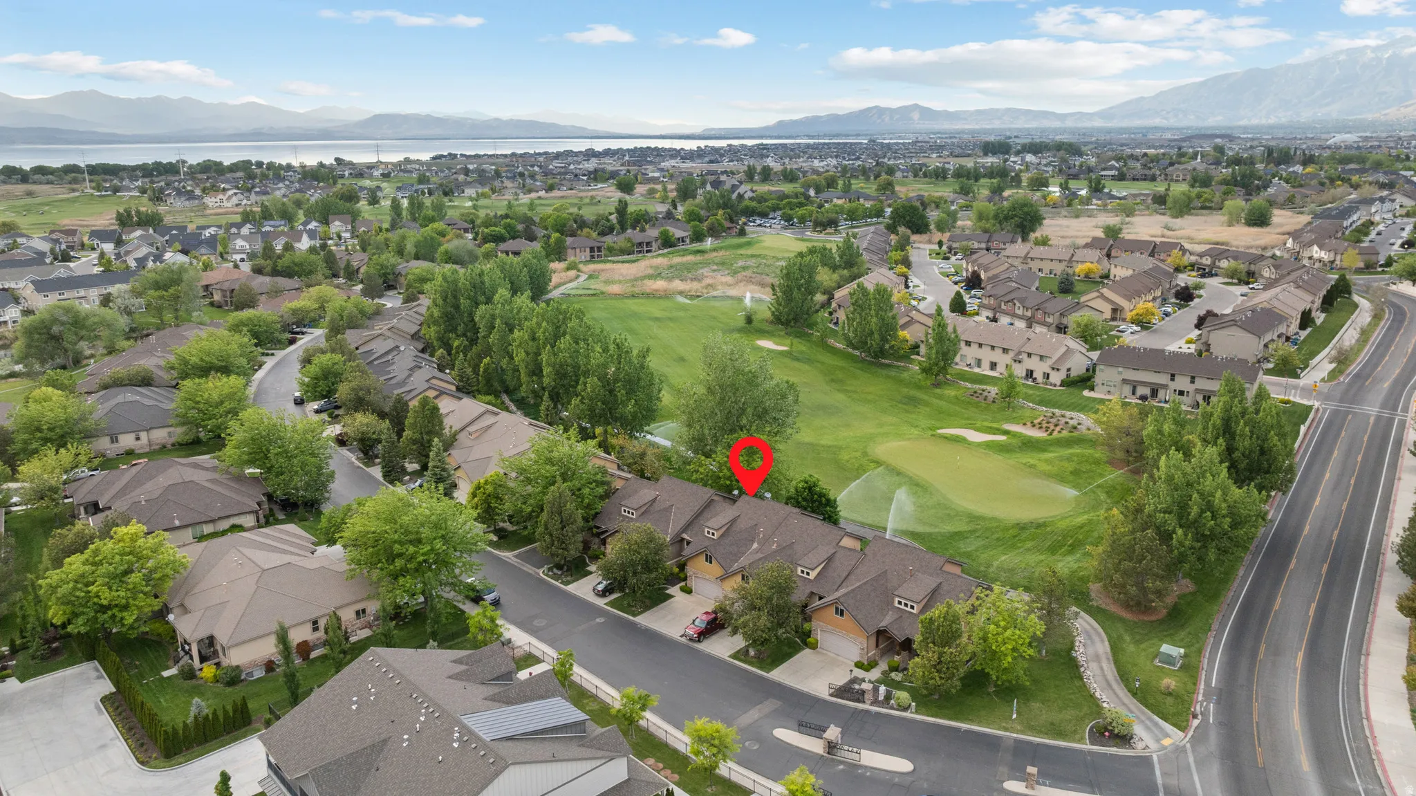 Aerial perspective of a residential community featuring townhomes and single-family residences