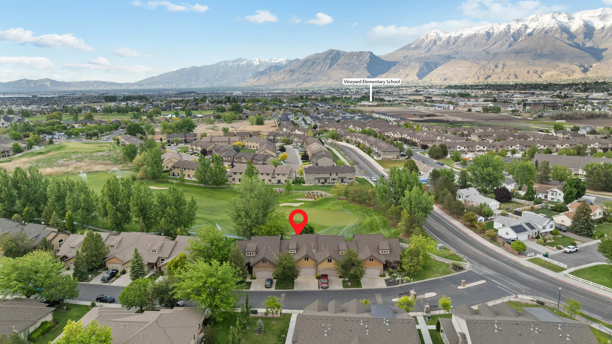 Aerial perspective highlighting Sleepy Ridge Golf Course with snow-capped mountains in the background