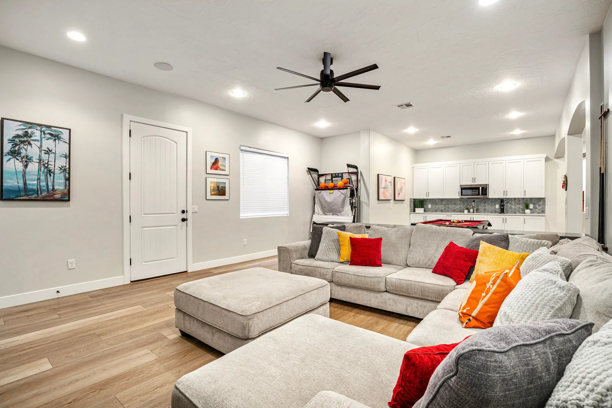 Spacious interior featuring wood-finish flooring, recessed lighting, and a modern ceiling fan