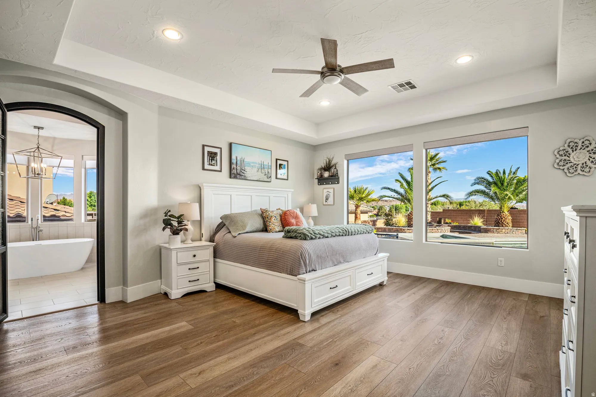 Tray ceiling featuring recessed lighting and a ceiling fan