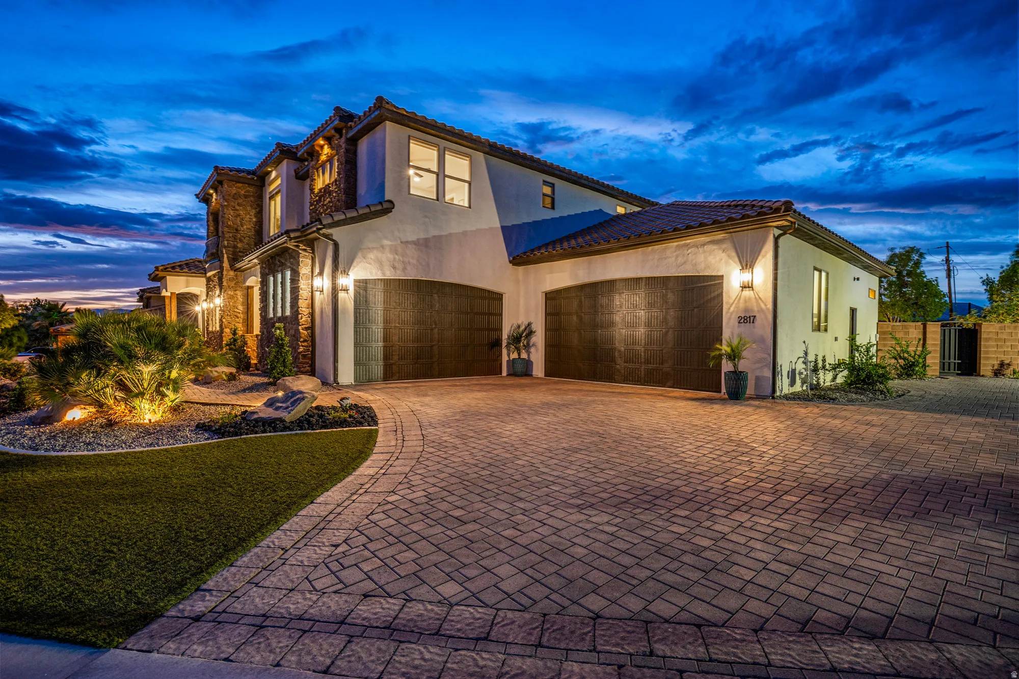Stucco exterior with stone accents and a terracotta tile roof