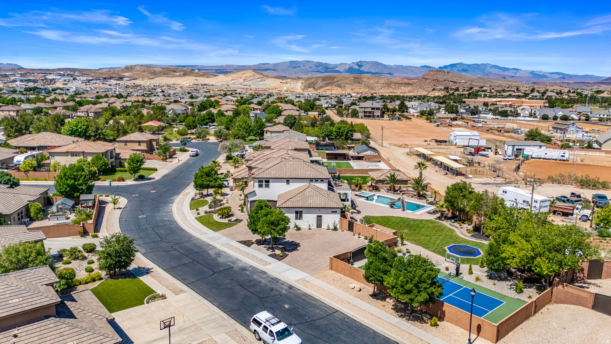 Aerial overview showcasing a residential neighborhood with arid landscaping and a prominent mountain backdrop