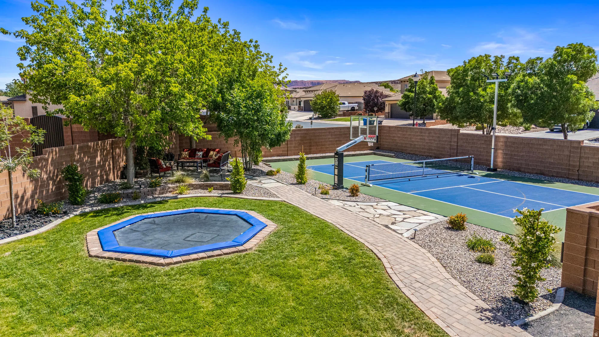 Expansive outdoor court featuring blue and green surfacing and a net