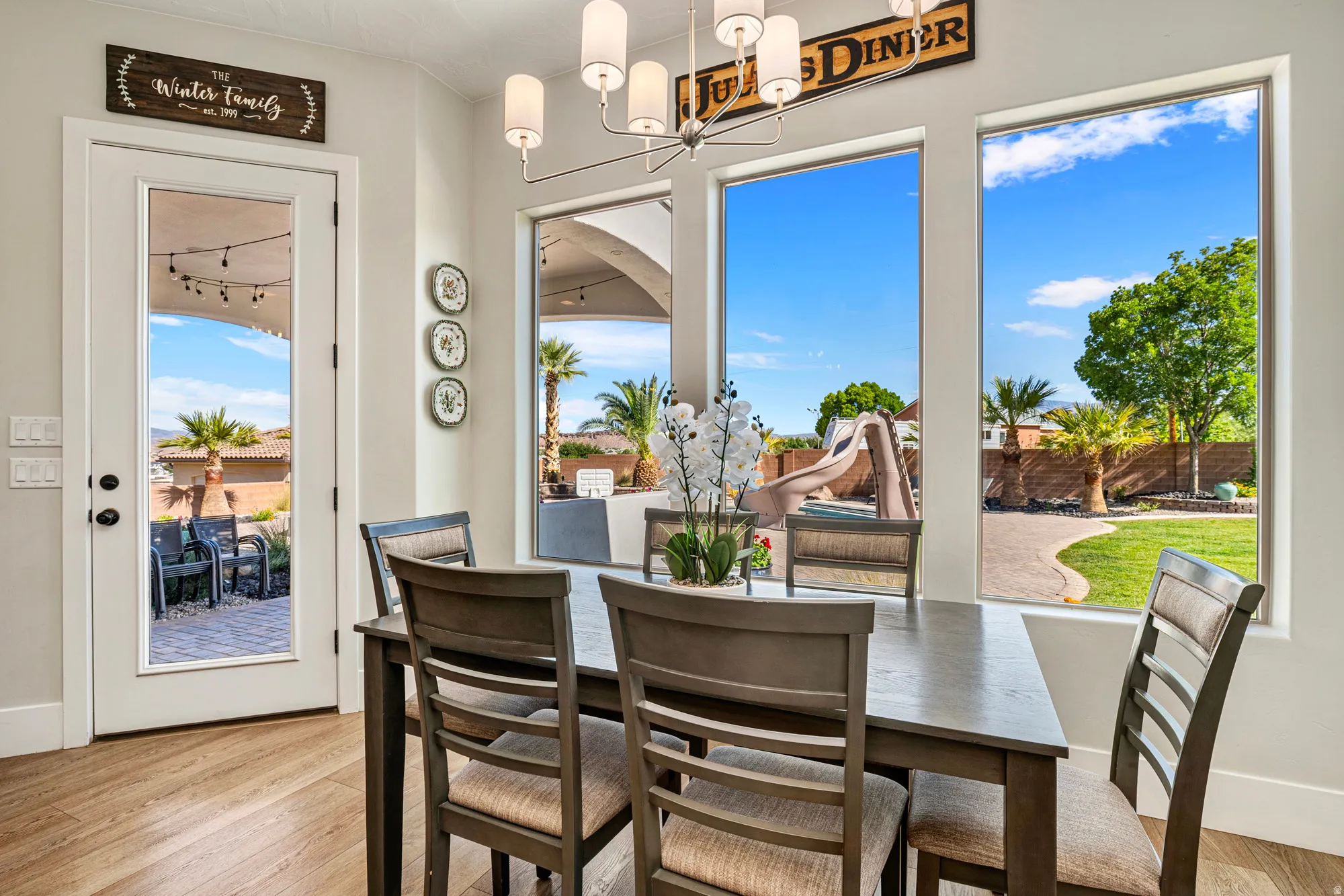 Open concept interior with wood-finish flooring and a contemporary chandelier