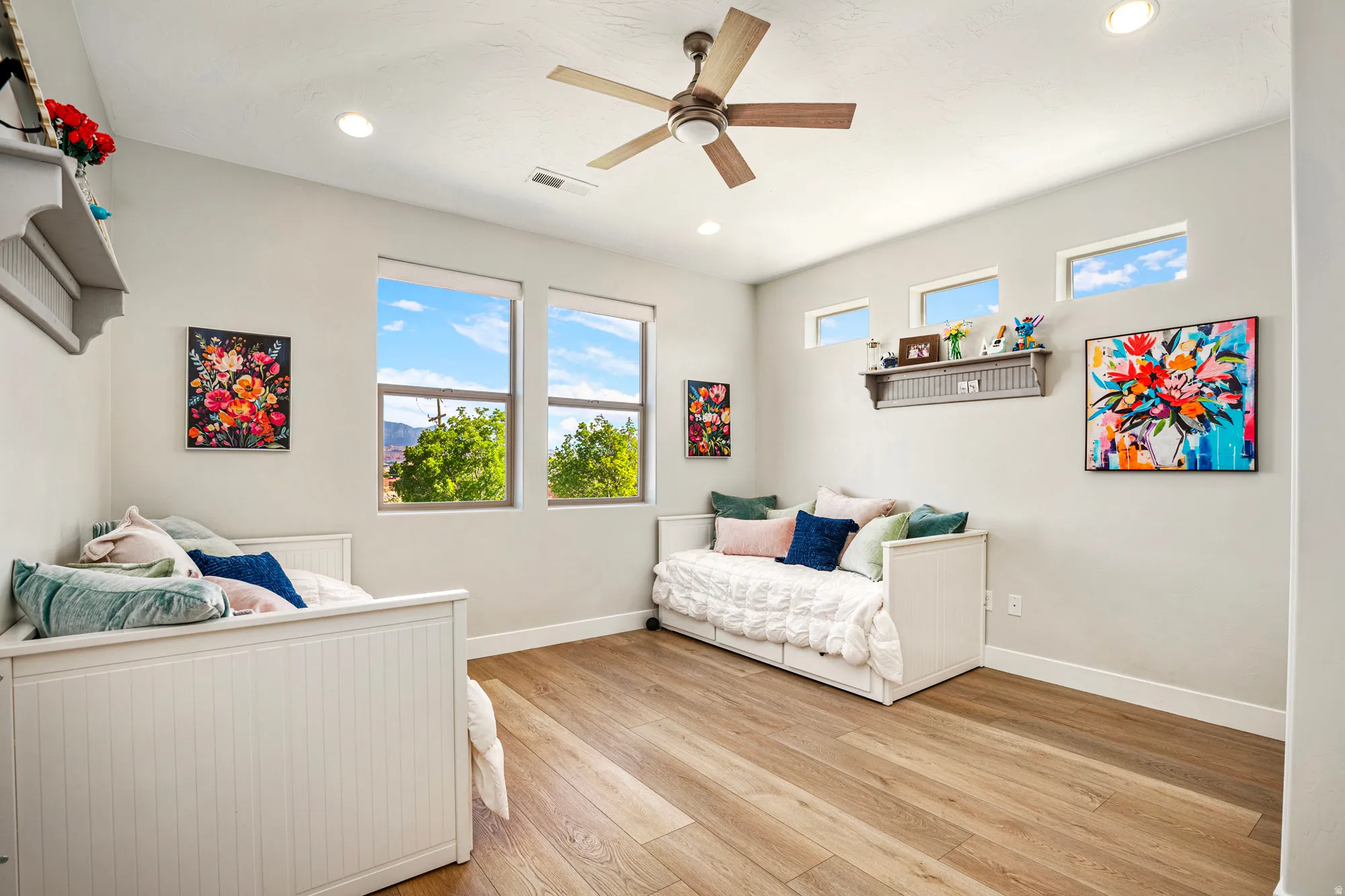 Bright interior space featuring wood-finish flooring, recessed lighting, and a ceiling fan