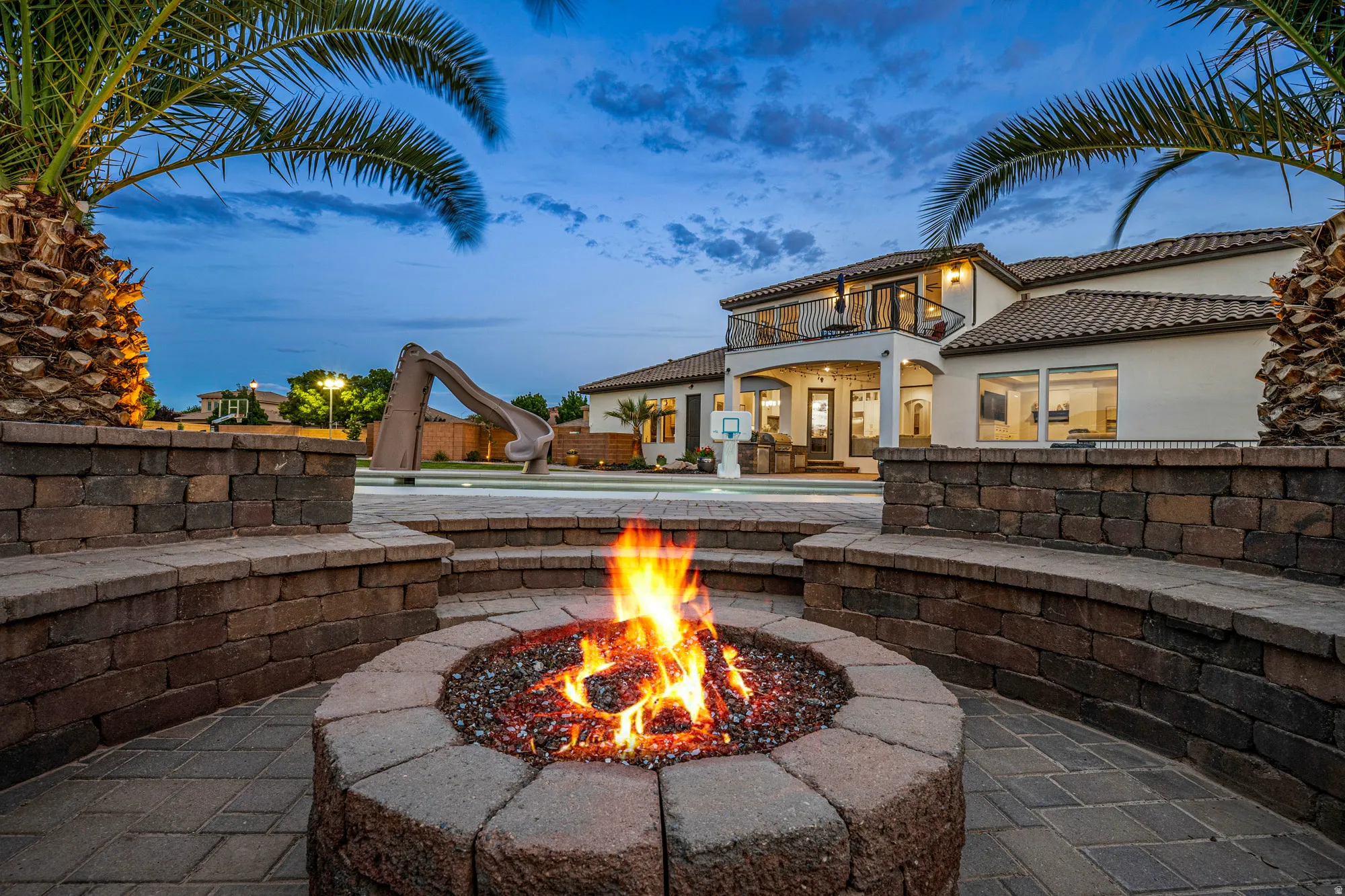 Hardscaped fire pit area with integrated seating walls