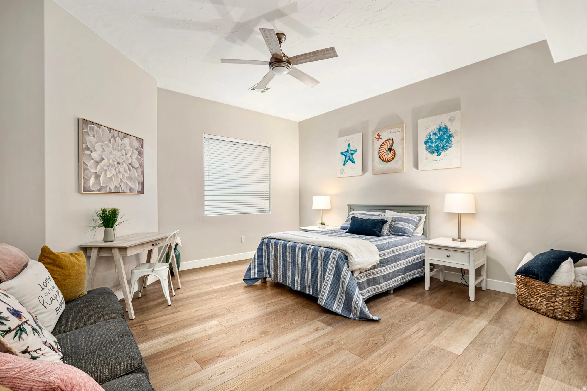 Spacious room featuring wood-finish flooring, a contemporary ceiling fan, and a built-in window with horizontal blinds