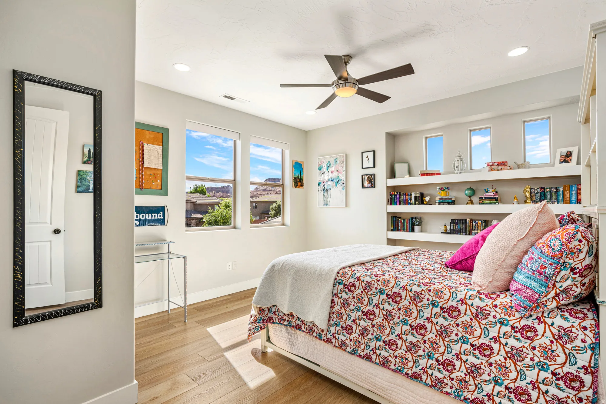 Bedroom featuring wood-finish flooring, a ceiling fan with integrated lighting, recessed lighting, and multiple windows providing natural light