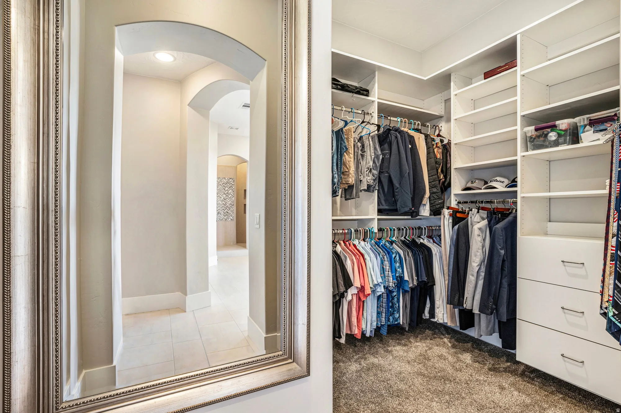 Custom closet system featuring multiple hanging rods, integrated shelving, and built-in drawers with modern hardware