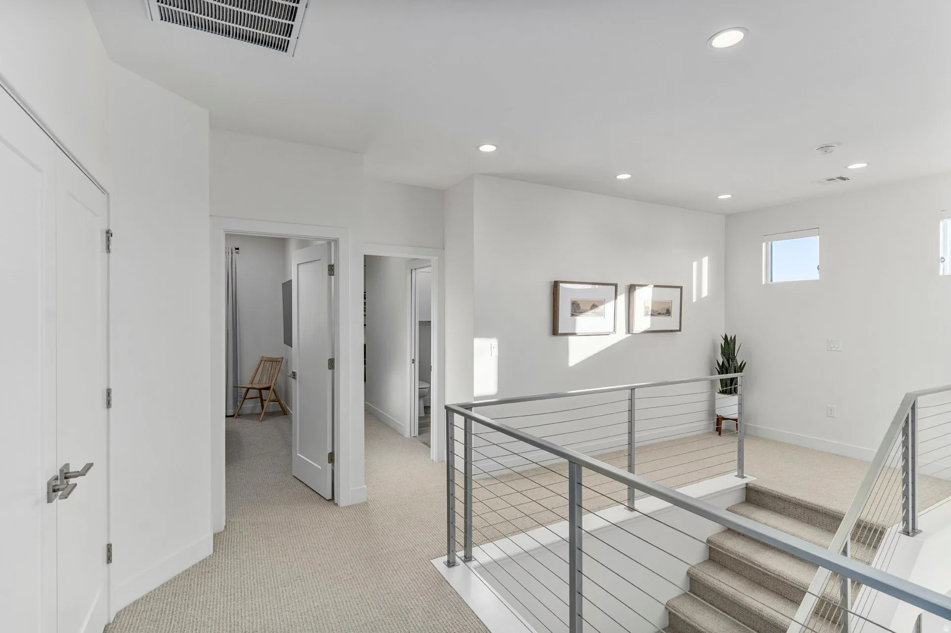 Upper level hallway featuring recessed lighting, light-colored carpet flooring, and white walls