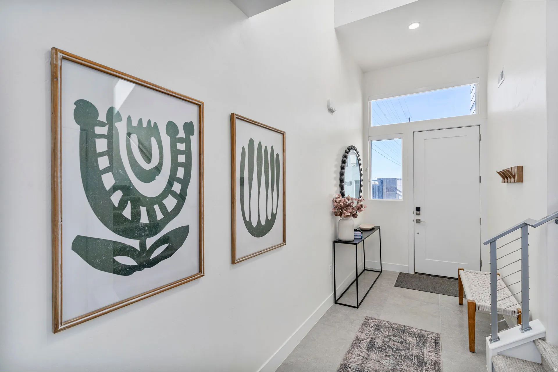 Entryway featuring high ceilings, a white door with transom and sidelight windows, recessed lighting, and light-toned flooring
