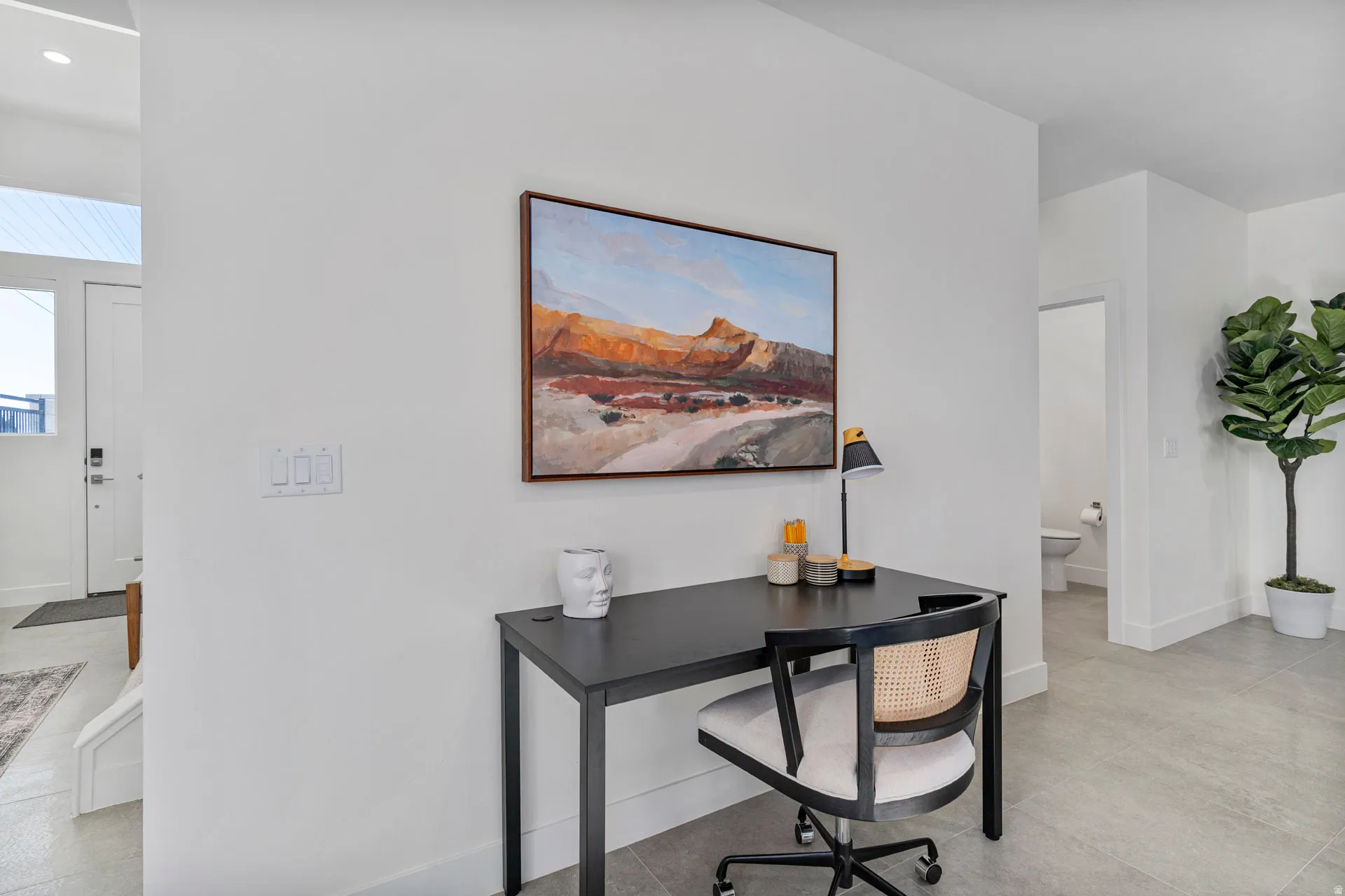 Entryway featuring light gray tile flooring, crisp white walls, and a recessed lighting fixture