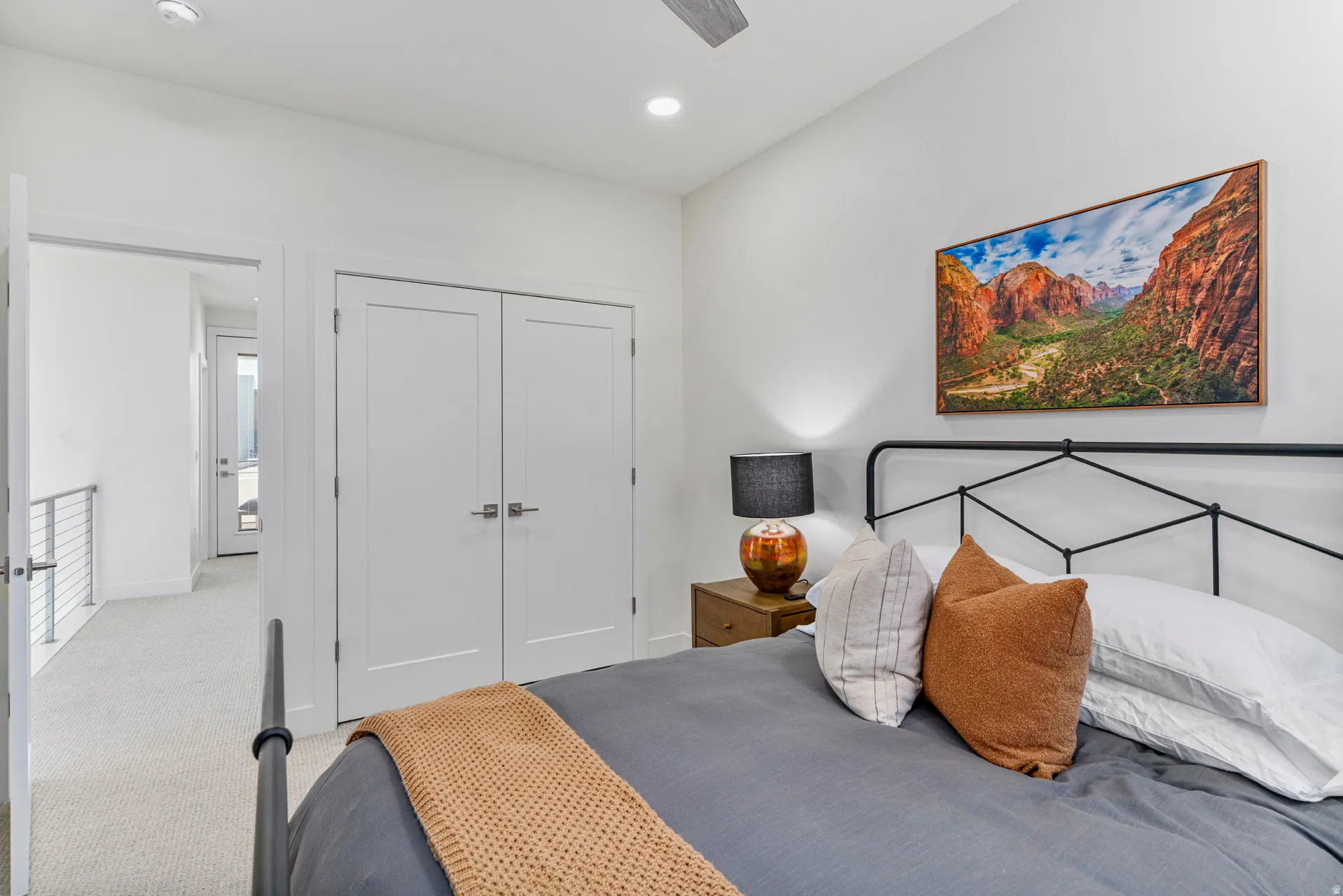 Second bedroom with white flat-panel double doors with brushed nickel hardware