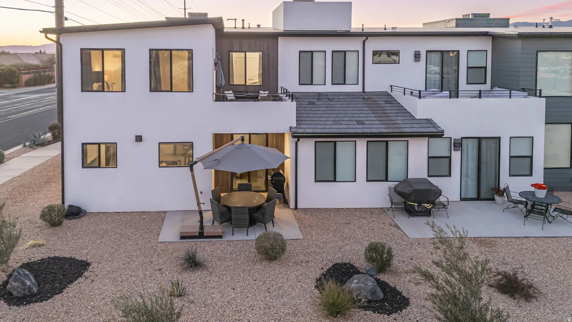 Contemporary multi-level exterior with white stucco and dark trim