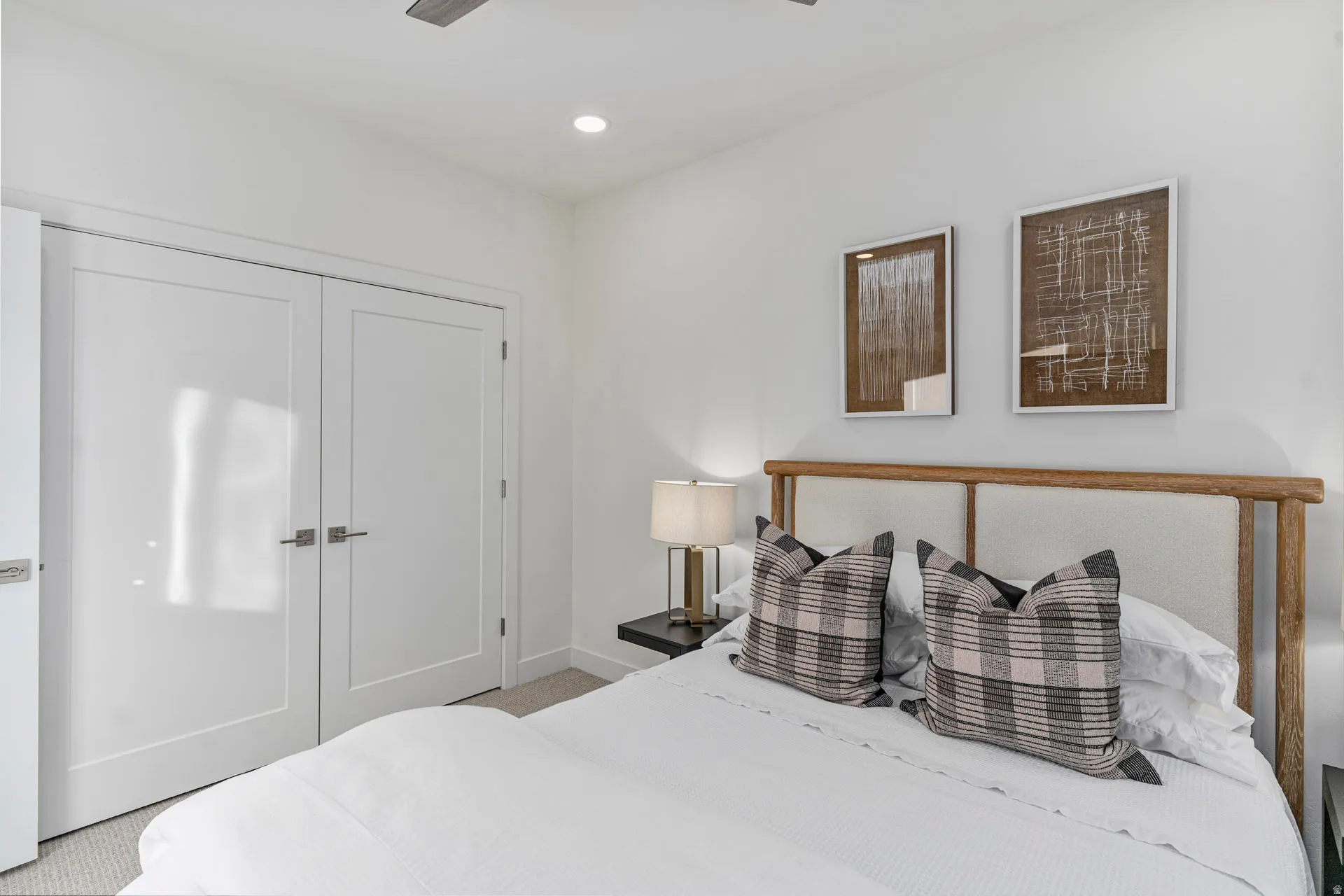 Third bedroom featuring double panel doors, recessed lighting, and soft carpet flooring