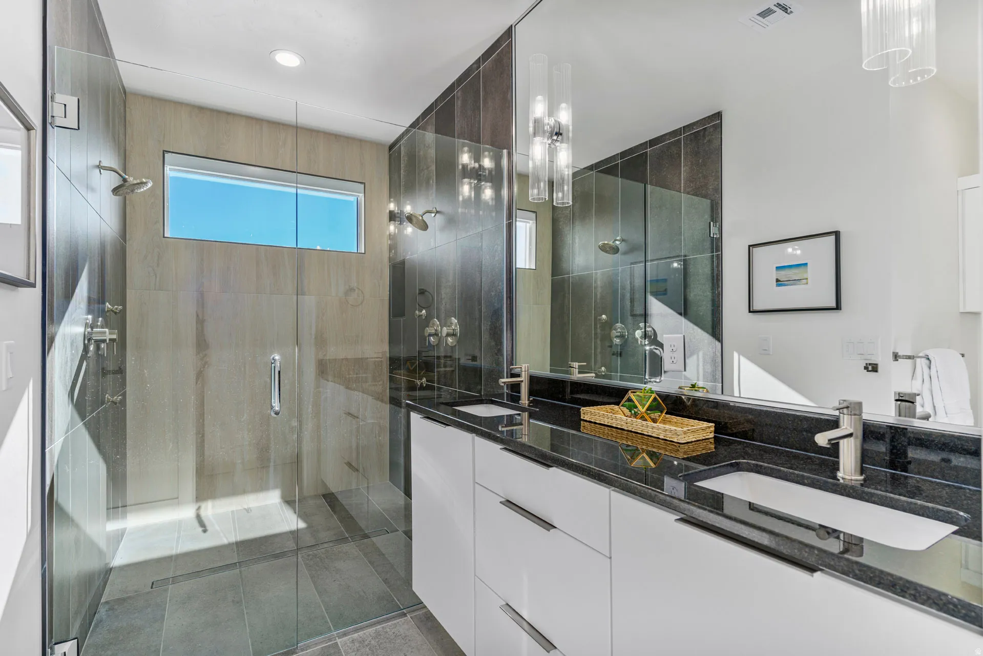 Primary contemporary bathroom featuring a spacious glass-enclosed shower with a transom window and large format tile