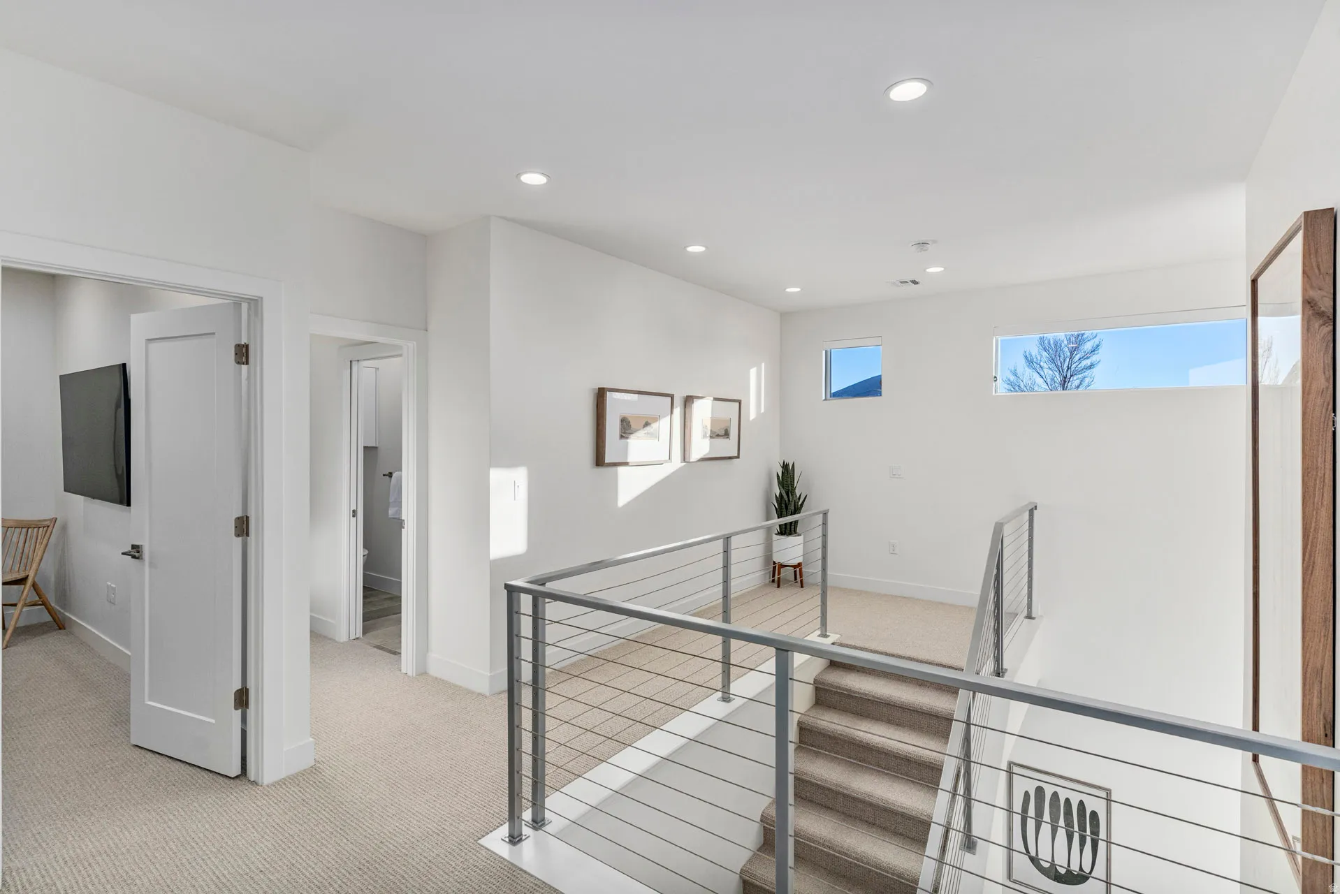Contemporary staircase with cable railing, recessed lighting, and high ceilings