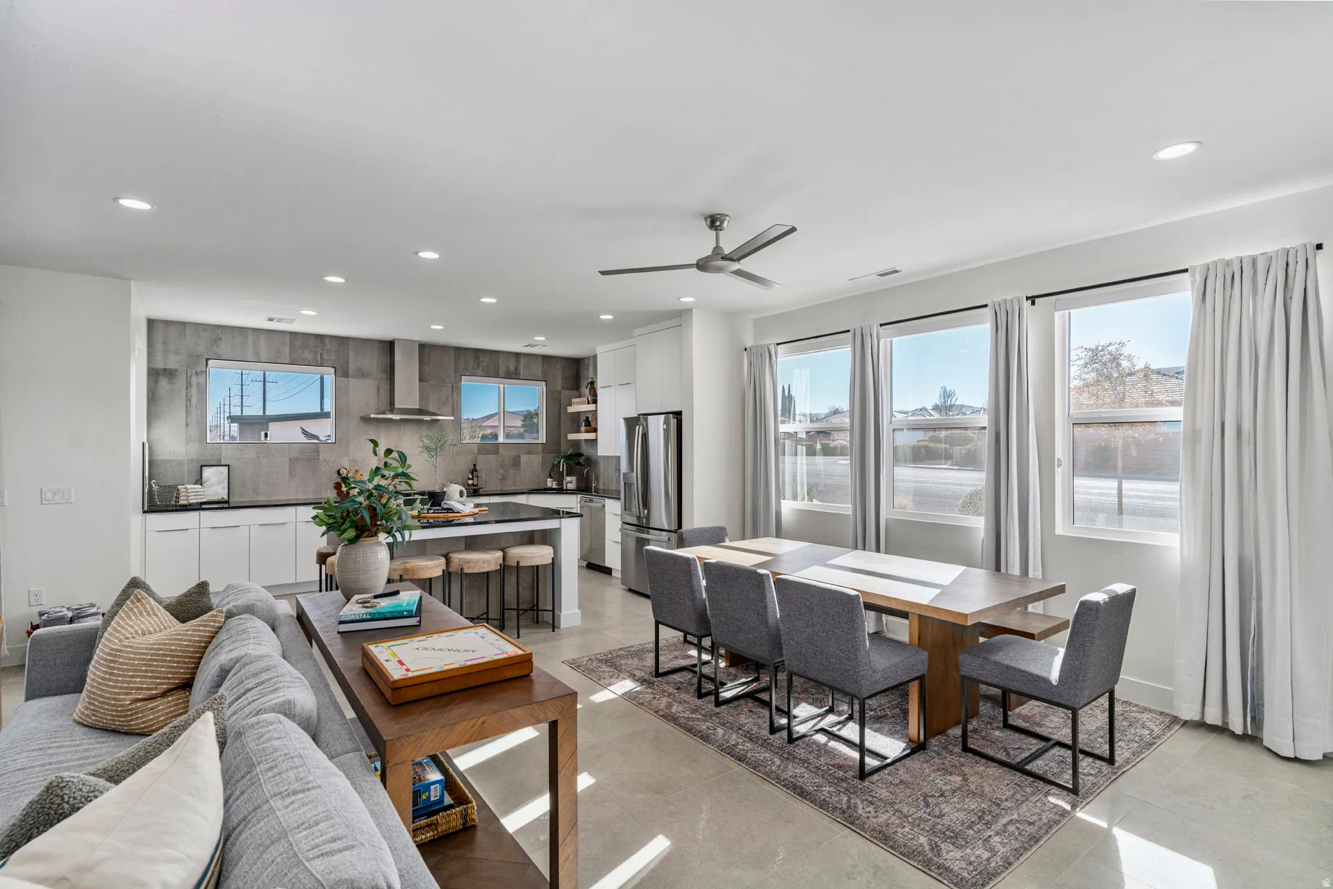 Open-concept living area with tile flooring, recessed lighting, and a modern ceiling fan