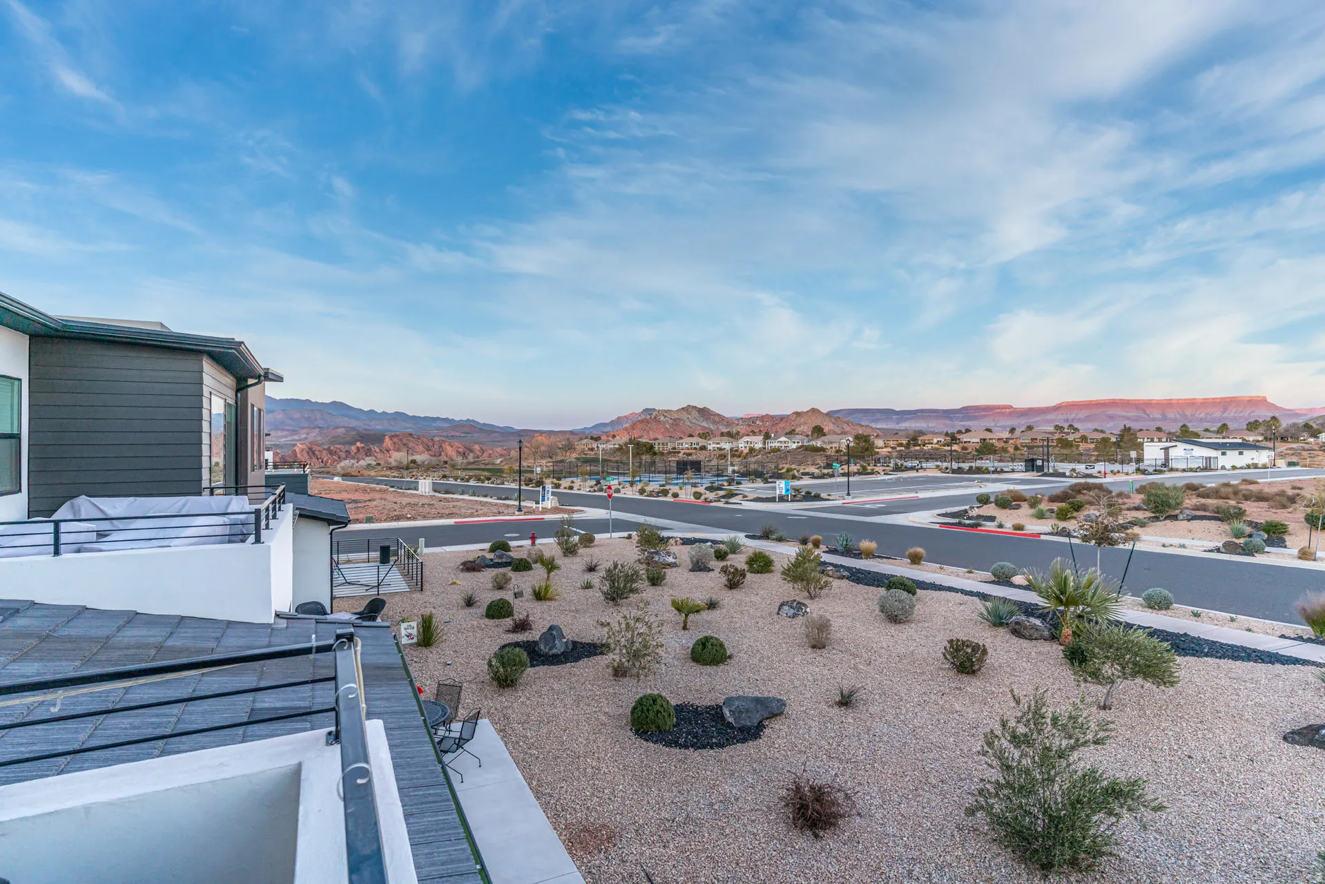 Rooftop deck off primary bedroom featuring metal railings, and desert landscaping