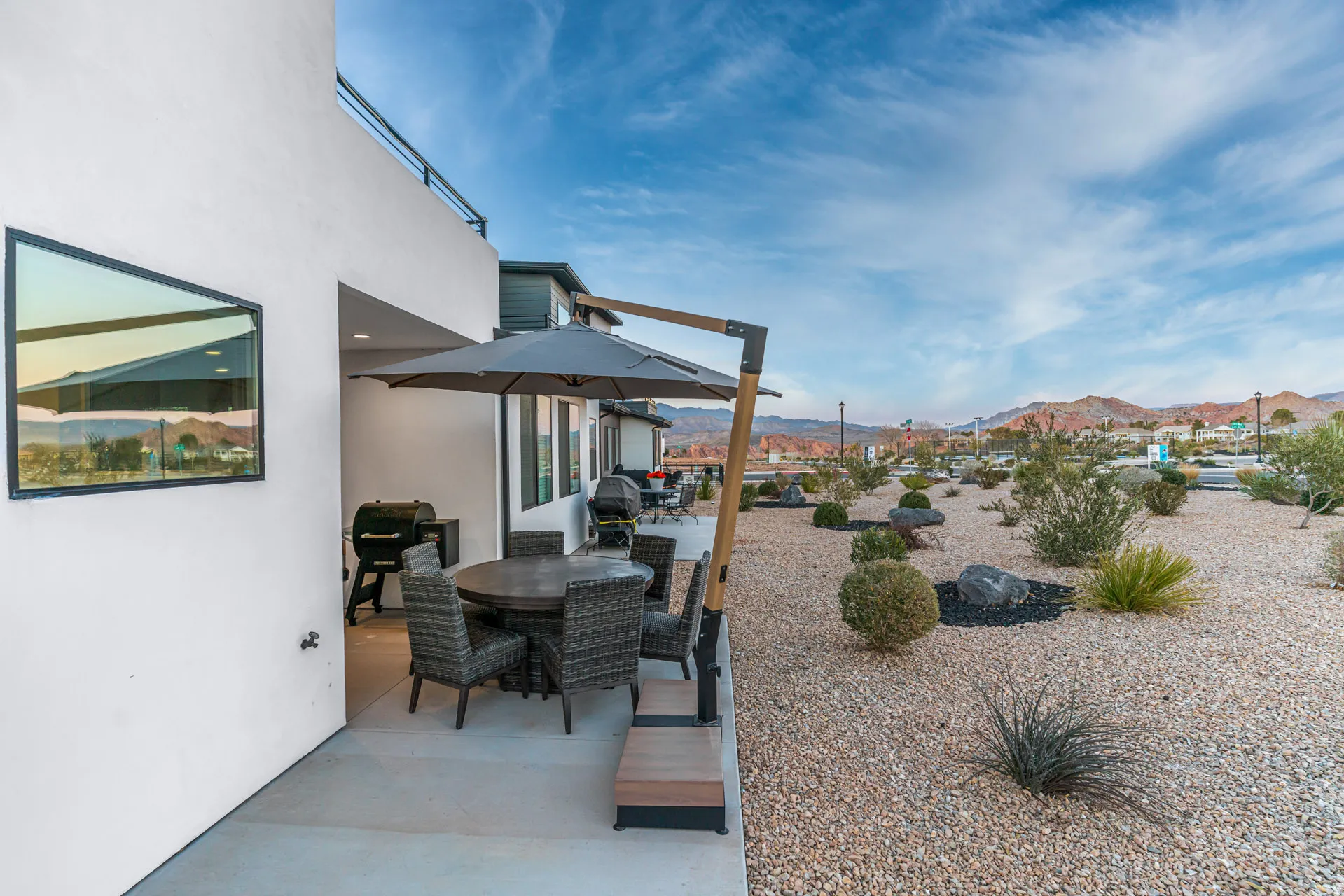 Outdoor patio featuring a concrete surface, built-in recessed lighting, and a modern exterior wall