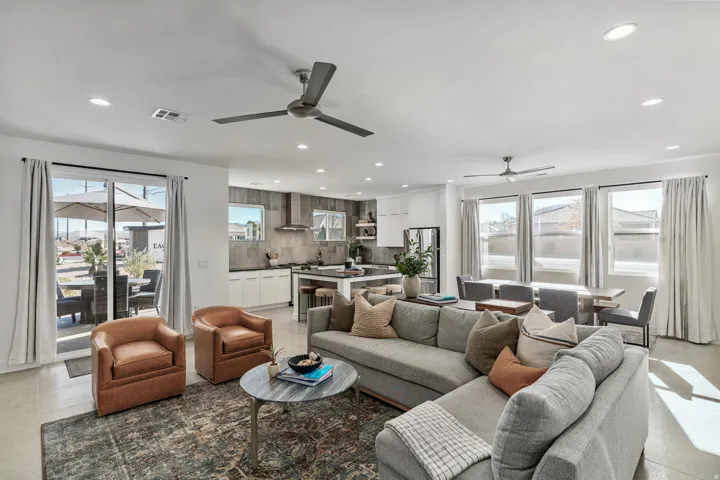 Open-concept living area featuring high ceilings, recessed lighting, and a contemporary ceiling fan
