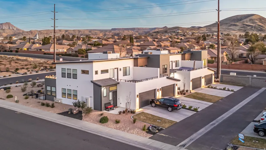 Contemporary multi-unit property featuring white stucco and dark gray siding