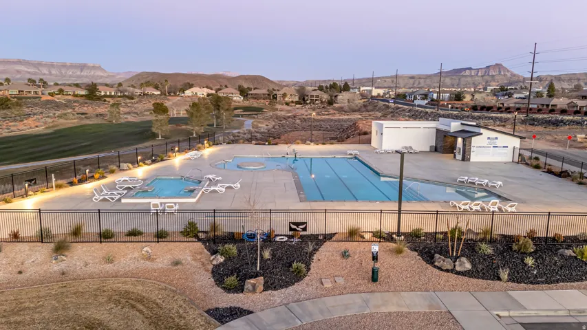 Community pool area featuring a lap pool, a separate recreation pool, and two integrated hot tubs