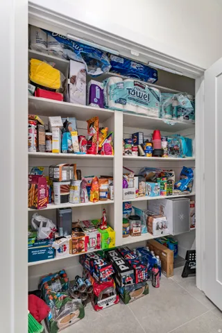 Built-in pantry shelving featuring multiple tiers and a durable tile flooring