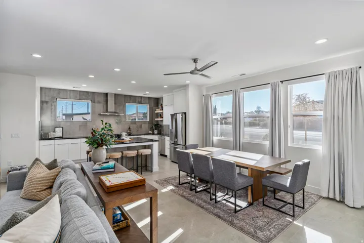 Open-concept living area with tile flooring, recessed lighting, and a modern ceiling fan